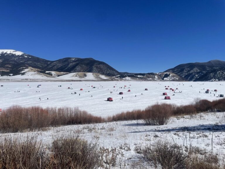 Kayak fisherman prepares for jigging on ice