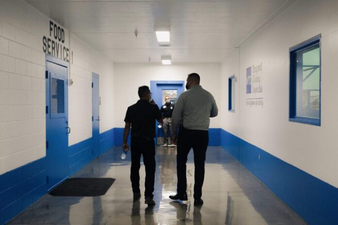 Staff walk the halls of the Otero County Processing Center.