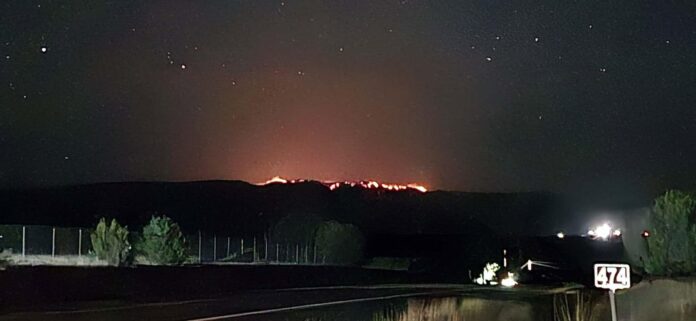 The glow from the Seven Cabins Fire northeast of Lincoln can be seen from the parking lot of the Spencer Theater on May 16.