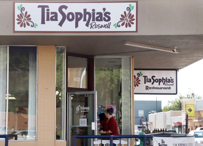 Courtenay Worthen, 32, walks her niece, Kaezee Service, 15, into Tia Sophia’s during breakfast hours July 27 in Roswell.