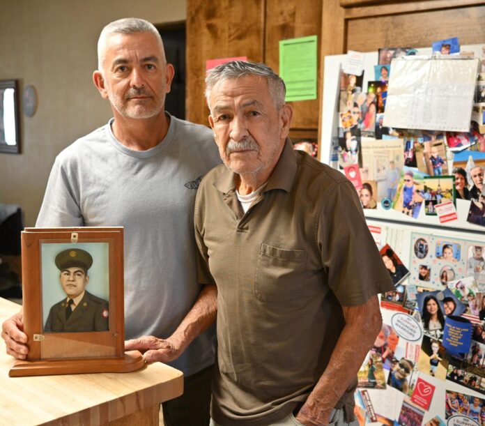 Mario Estrada (left) and Pete Estrada (right) vow to continue the effort to win the Medal of Honor for war hero Willie Estrada (pictured).