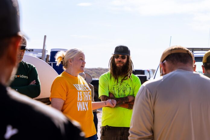 Mary Garwood and Trevor Fray meet with volunteers to discuss installing a disc golf course at Six Mile Dam during Day of Caring in Carlsbad on Sept. 18, 2025.