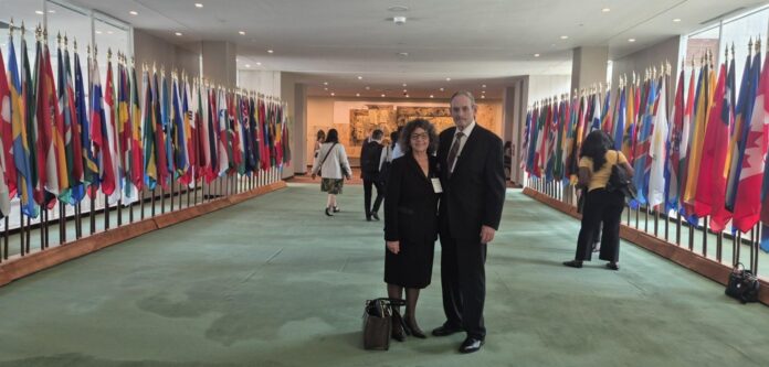 Tina Cordova poses with her partner, Russ Steward, during her trip to the United Nations