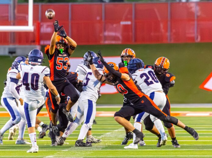 Artesia linebacker Elijah Carrasco and defensive end Ivan Chavez almost block a Deming punt.