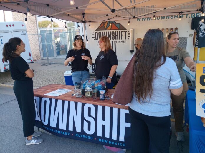 Staff from Downshift Brewery serve customers during the opening night of the Red Dirt Black Gold Festival in Artesia.
