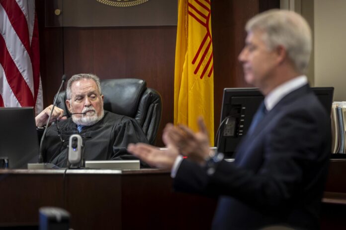 Judge Francis Mathew, left, listens to the closing statements made by Dane Butswinkas, an attorney representing Meta, on September 23, 2026, in the First Judicial District Court in Santa Fe.