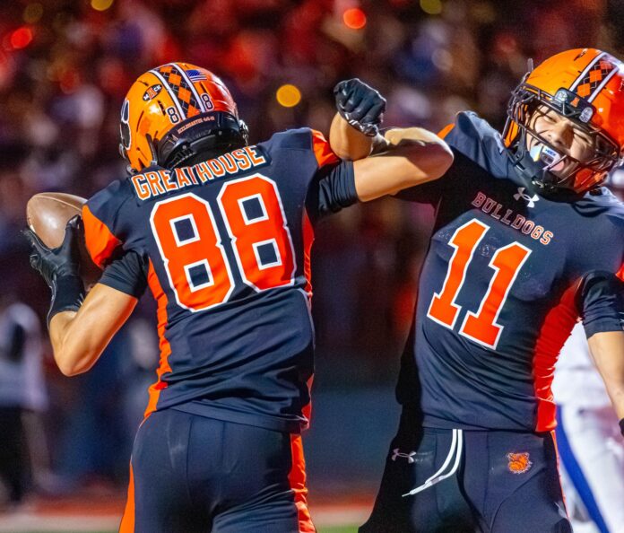 Artesia running back Cristian Pando congratulates wide receiver Kai Greathouse after scoring a touchdown.