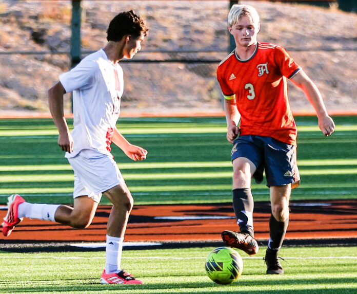 Artesia soccer player Samuel Nielson tries to go around a Portales defender during Senior Day action on Saturday at Robert Chase Field.