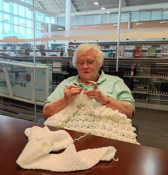 Sandy Schuetz crochets an afghan during the Sept. 23, 2026 meeting of Yarn United at the Artesia Public Library.