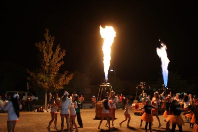 The Artesia High School cheerleaders dance at the 2025 Balloon and Tunes fire concert.
