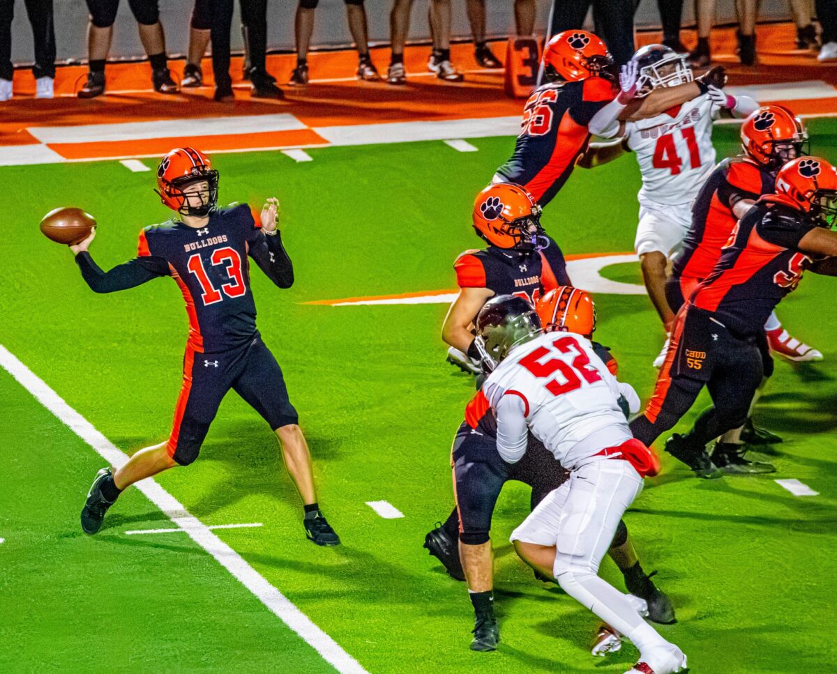 Artesia quarterback Lucas Atkins throws a pass against Roswell during a game at the Bulldog Bowl.